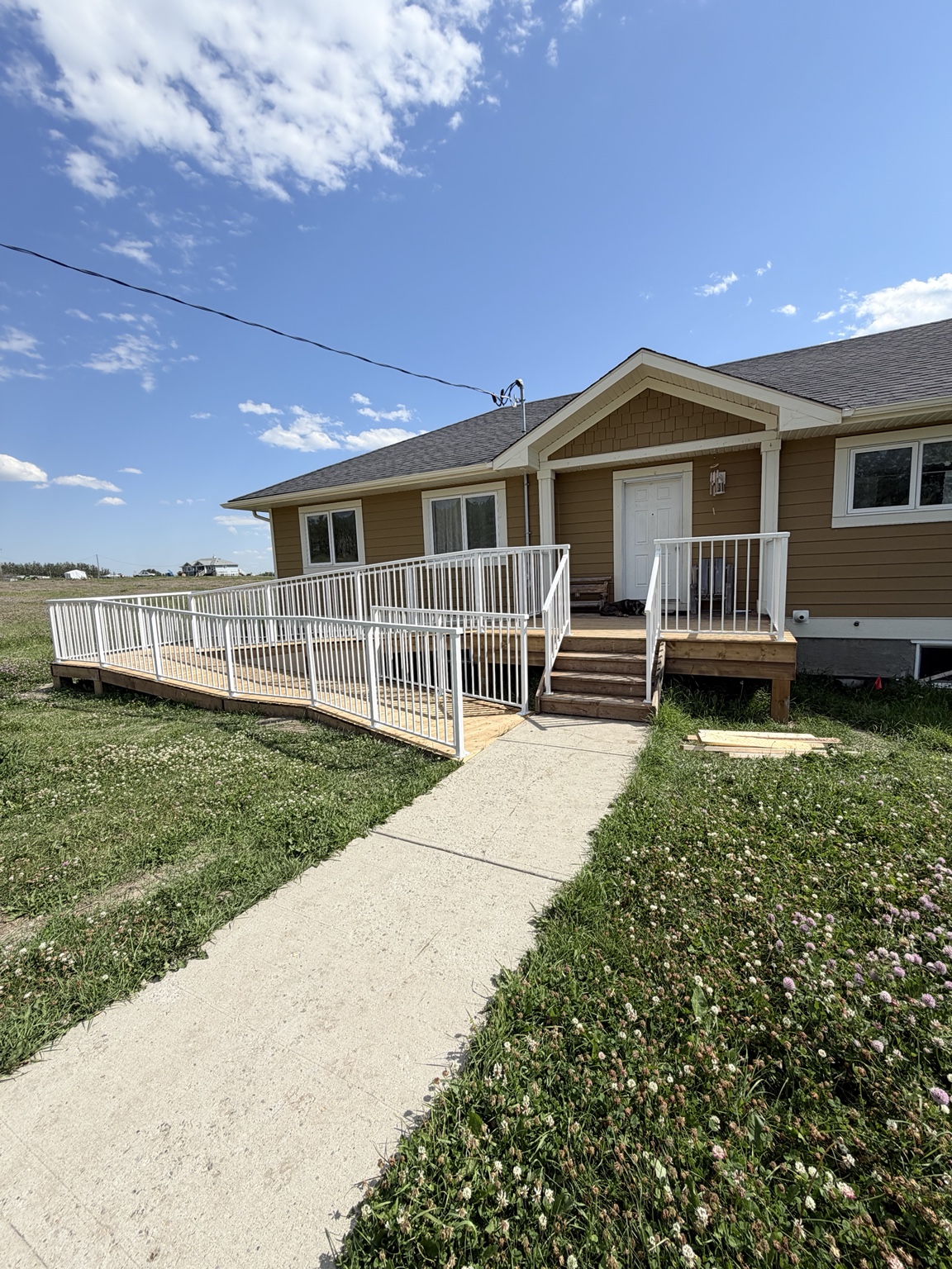 White aluminum railings along a deck and accessibility ramp