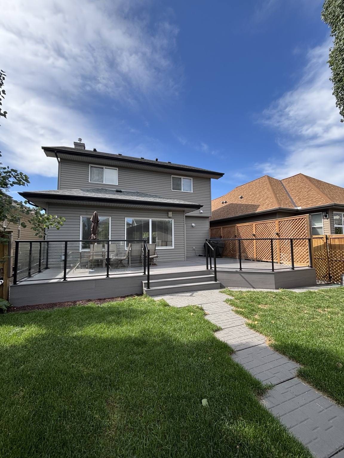 Finished backyard deck with modern black horizontal railing