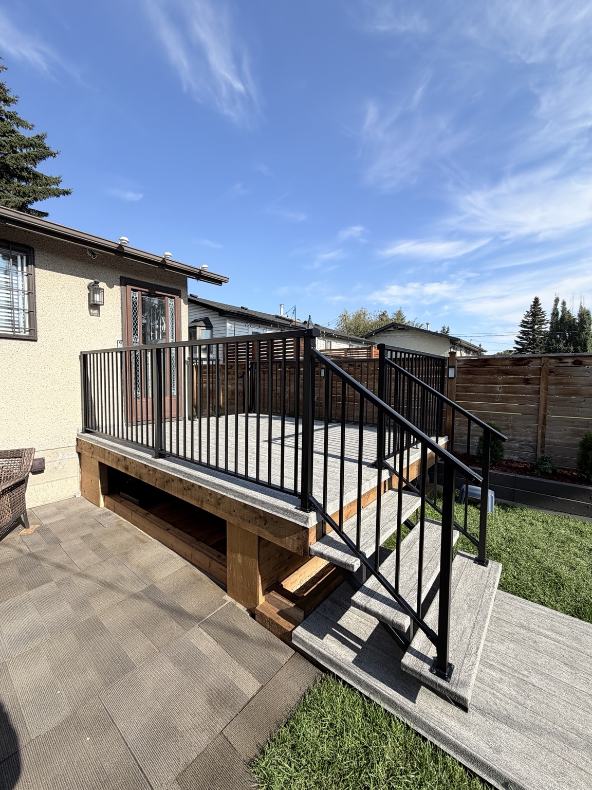 Black aluminum picket railing on a grey deck
