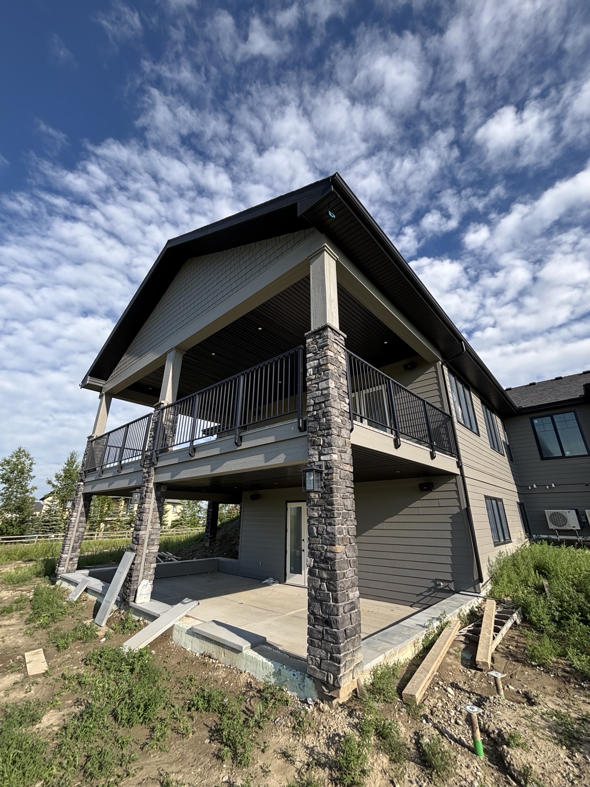 Custom covered raised deck with black aluminum railing