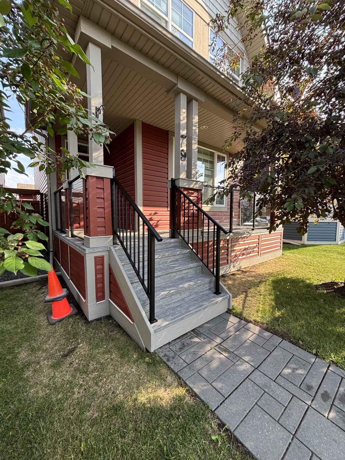 Front porch and steps finished with black aluminum railing