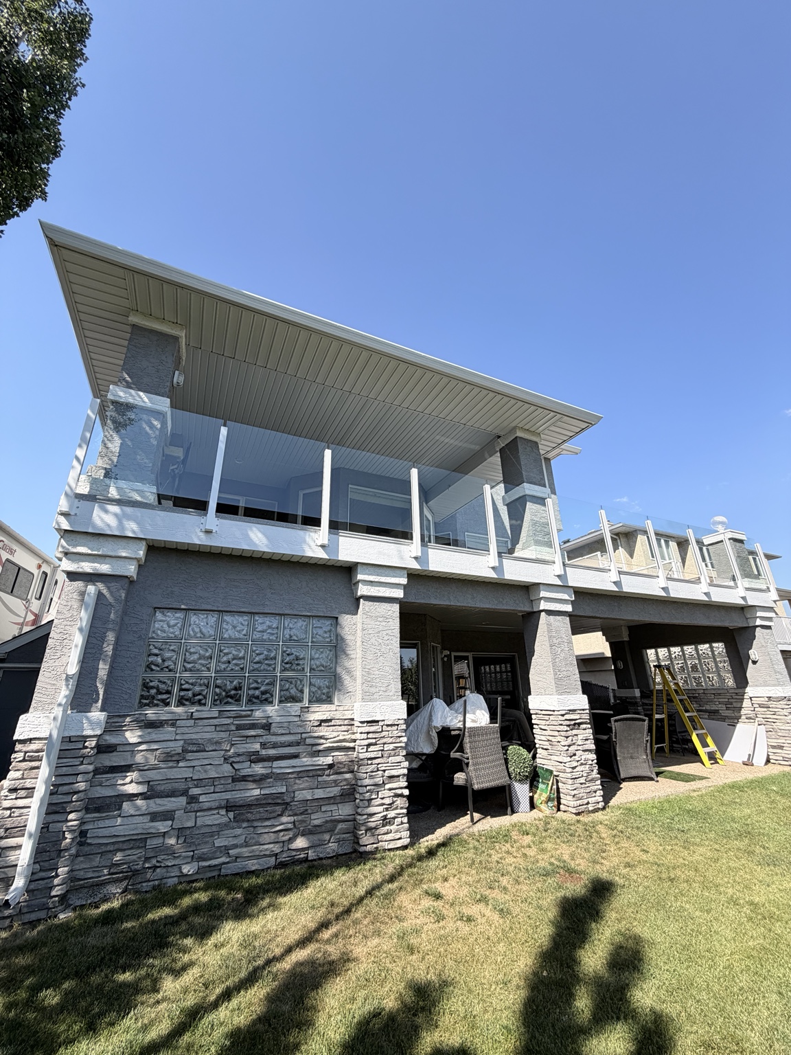 Second-storey deck finished with glass railings