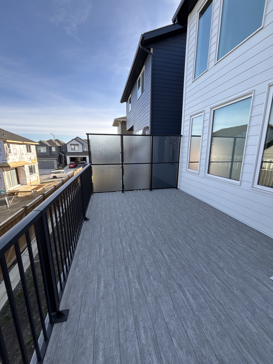 Grey waterproof vinyl deck with black glass railing