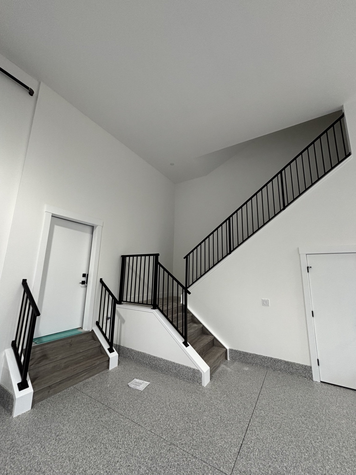 Modern interior staircase finished with black powder-coated aluminum railing