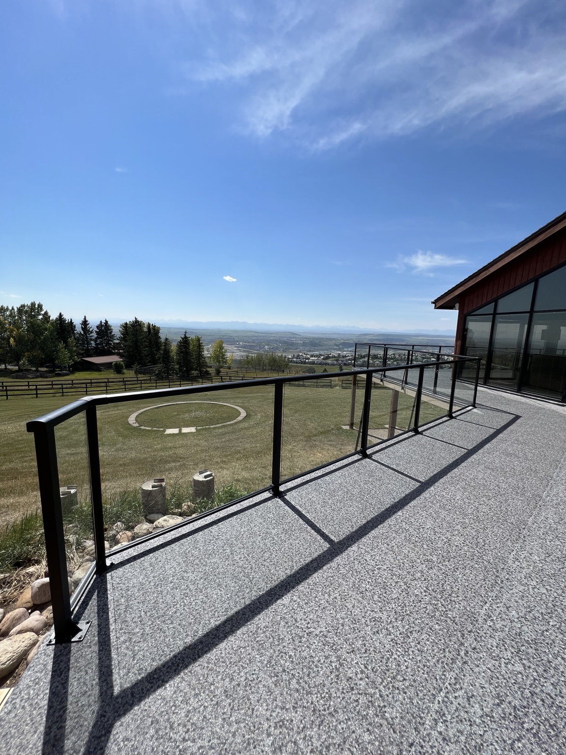 Premium waterproof vinyl deck and black glass railing overlooking the mountains