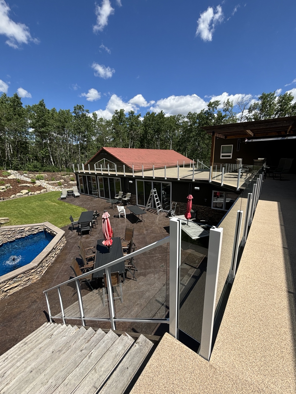 Elevated pool deck with black glass railing