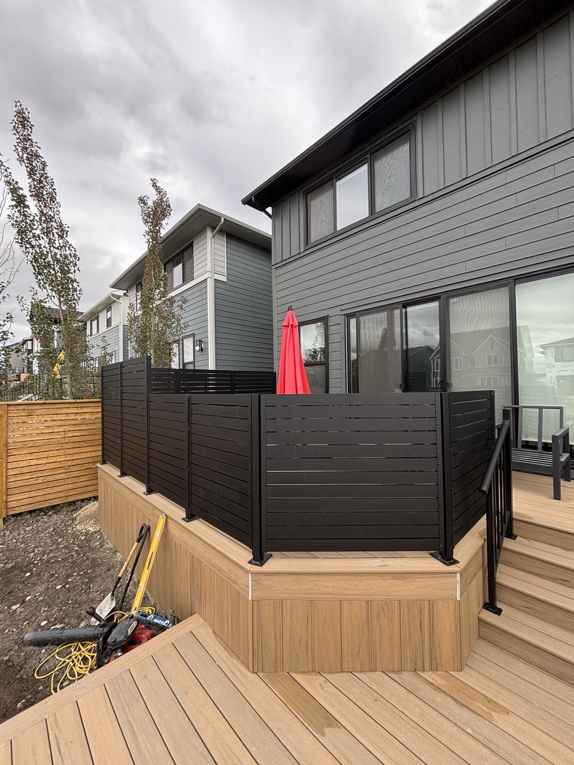 Wood deck with black privacy railing panels