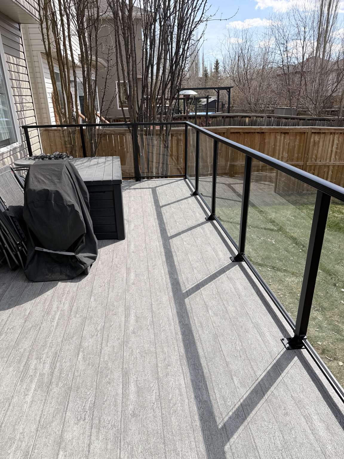 Close view of the waterproof vinyl deck surface and glass railing