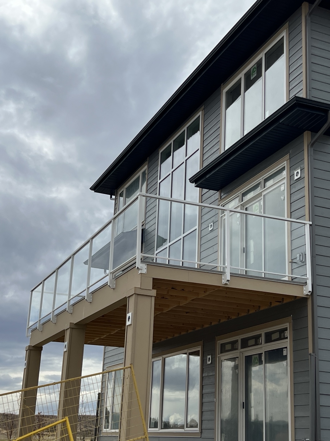 Elevated balcony with white aluminum and glass railing