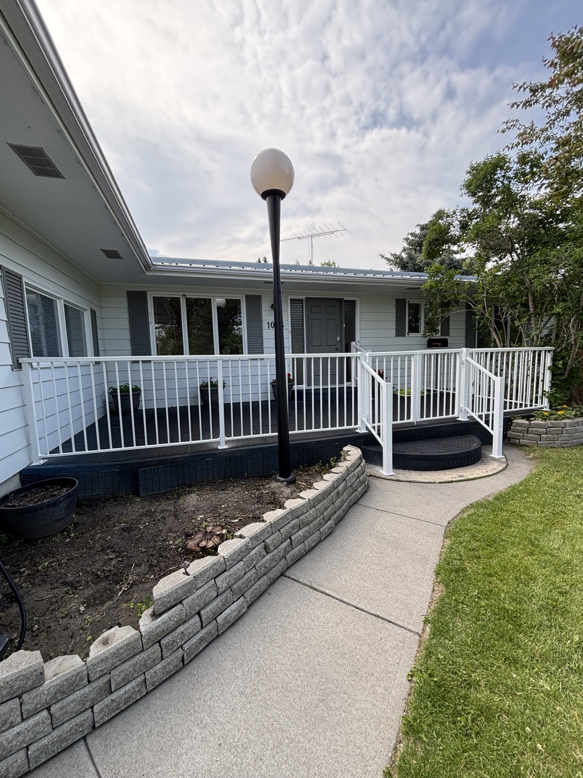 Large backyard deck with white aluminum picket railing