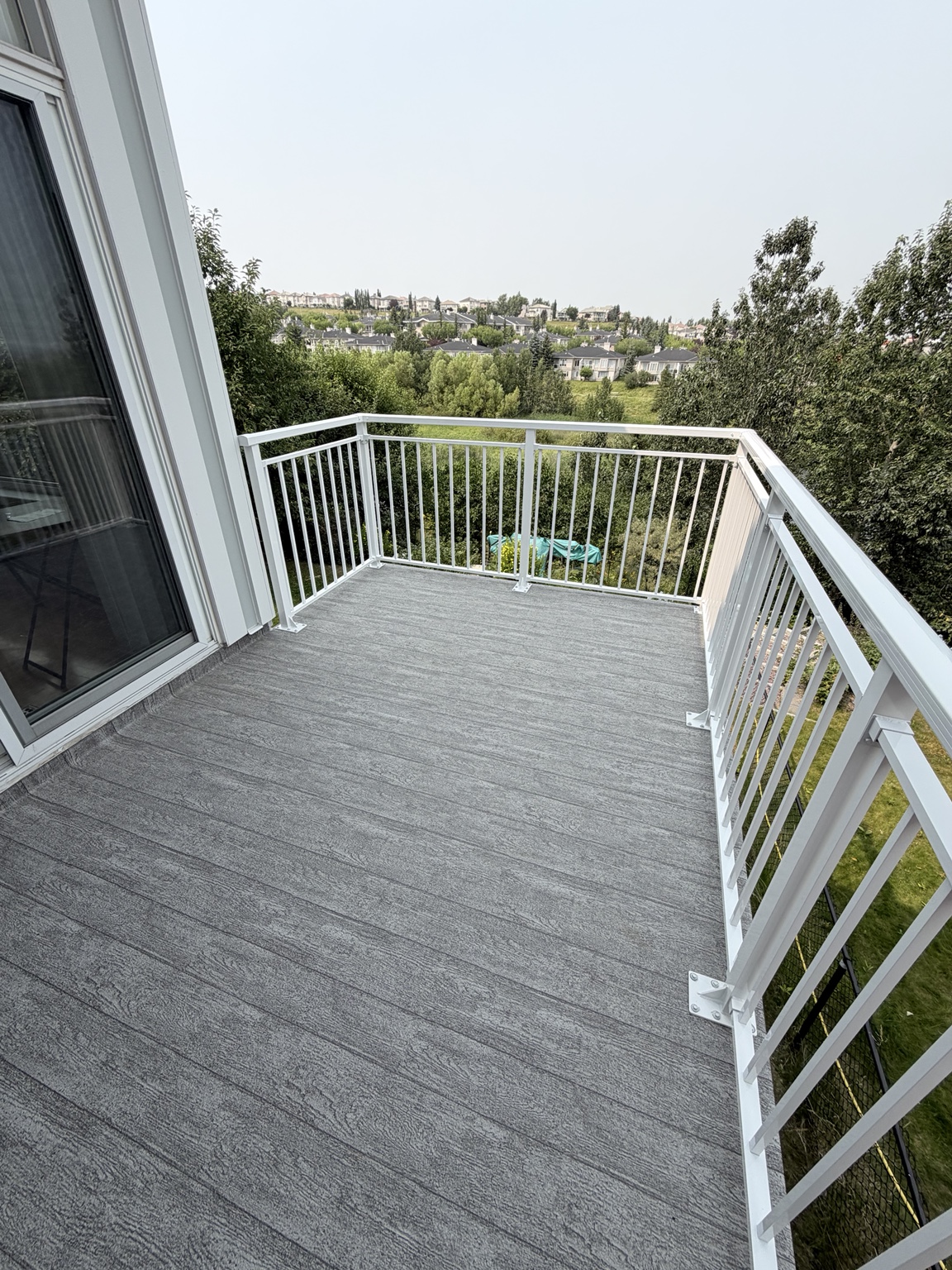 White aluminum railing and grey waterproof vinyl balcony