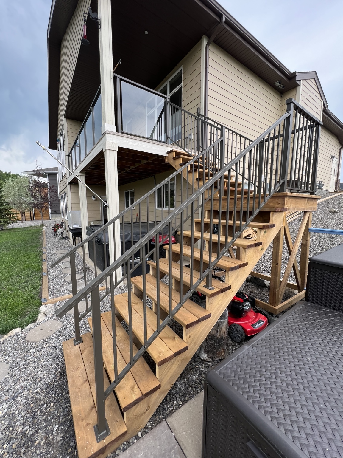 Wood staircase with fitted black aluminum railing